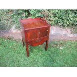 A 19th century mahogany tray top commode, with cupboard below, on brass castors, 22ins x 19ins x