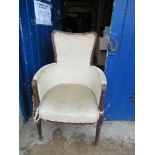 A 19th century mahogany and upholstered armchair, with reeded supports to the arms and raised on