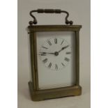 A gilt metal cased carriage clock, with white enamel dial and Roman numerals, height with handle 5.