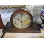 An oak cased mantel clock