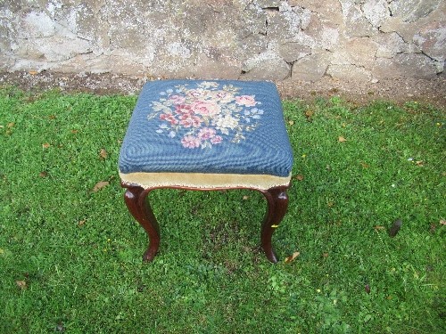 A Victorian mahogany stool, with Berlin woolwork top, raised on cabriole legs, 16ins x 15ins x