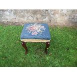 A Victorian mahogany stool, with Berlin woolwork top, raised on cabriole legs, 16ins x 15ins x