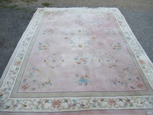 A Chinese wool wash rug, in pink, 122ins x 95.5ins