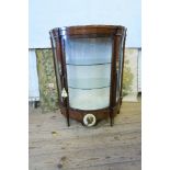 A continental style bow fronted display cabinet, having ormulu mounts and neo classical