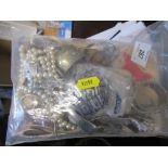 A bag of silver napkin rings, spoons, beads and other items