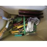 A box of tools and hunting prints