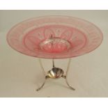 A cranberry and clear glass bowl, with etched decoration, raised on a silver plated stand,