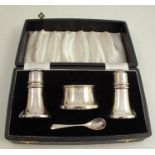 A cased hallmarked silver three piece cruet set