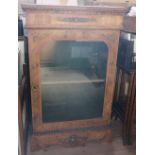 A Victorian walnut pier cabinet, with glazed door and gilt metal mounts, height 43ins, width