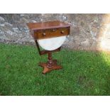 A Victorian mahogany sewing table, with frieze drawer, raised on a turned pedestal terminating in