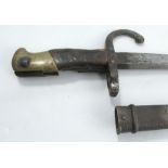 A French bayonet, with scabbard, the blade engraved and dated 1876