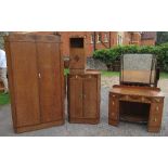 An Art Deco style oak bedroom suite, comprising two single beds, a wardrobe, tallboy, bedside