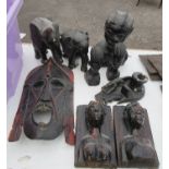 A group of carved tribal figures, to include book ends, masks, etc.
