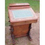 A Victorian walnut davenport, with birds eye maple interior, fitted with drawers and dummy