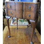 A walnut side table, with shaped front, fitted with two graduated drawers, raised on cabriole