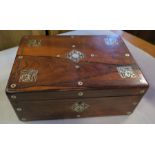 A Victorian rosewood writing box, of rectangular form, the top and front with mother of pearl inlay,