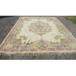 A Begum Indian rug, decorated with flowers to a cream ground, 127ins x 108ins