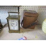 A brass cased carriage clock, with leather covered travel case