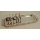 A silver five bar toast rack and rectangular tray, with gadrooned edge to the tray and handles,