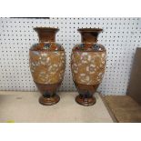 A pair of Doulton Slaters patent vases, decorated in browns and blues with incised relief