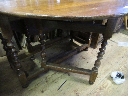 An oval oak gate leg table, raised on barley twist supports, width 42ins - Image 2 of 2