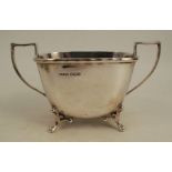 A silver two handled sugar bowl, of rectangular form, raised on four scroll legs, Sheffield 1933,