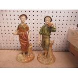 A pair of Royal Worcester figures, a young man with an axe and a woman with a bucket, height 7ins
