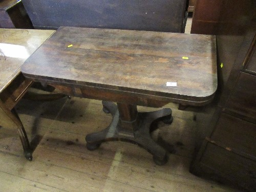 A 19th century rosewood fold over table, raised on a column terminating in a platform base, width