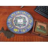 An enamel decorated plate, together with a letter clip and coasters