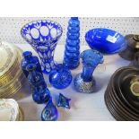 A collection of blue glass items, to include vases and models