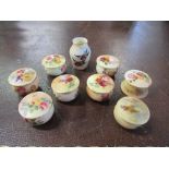 A collection of Royal Worcester covered pots, seven decorated with painted flowers, one with