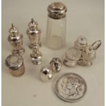 A collection of condiment pots, to include a hallmarked silver cruet frame holding three glass and