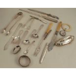 A collection of flatware, to include mainly hallmarked silver, sugar tongs, butter knife, spoons,