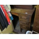 An oak knee hole desk, fitted with a central drawer flanked by three drawers to each side, 42ins x