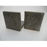 A pair of beaten pewter book ends, embossed with squirrels holding acorns, height 4.75ins