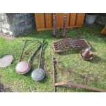 A collection of metalware, to include a pair of fire dogs, a grate, swing arms, warming pans etc