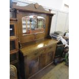 An Edwardian Art Nouveau style mirror back sideboard, with two drawers over two part carved doors,