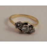 A three stone diamond ring, stamped '18ct', the graduated brilliant cuts totalling approximately 0.