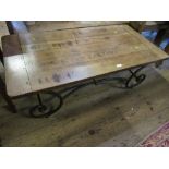 A pair of cleated plank top tables, raised on low modern scrolling iron supports, 24ins x 48ins x