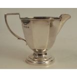 A silver jug, with octagonal body, raised on a circular pedestal foot, Birmingham 1913, weight 2oz