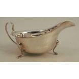 A silver sauce boat, with shaped edge, raised on three scroll feet, Sheffield 1956, weight 3oz