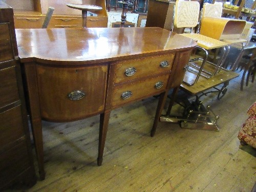 A 19th century cross banded break bow front sideboard, fitted with two central drawers flanked by