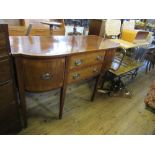 A 19th century cross banded break bow front sideboard, fitted with two central drawers flanked by
