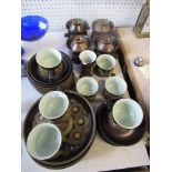 A brown part coffee service and soup bowls
