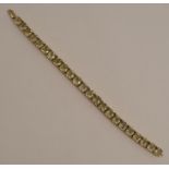 A citrine 9 carat gold bracelet, set with twenty three cushion shaped stones, 19cm long, 20g gross