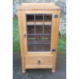 A Robert Mouseman Thompson oak glazed cabinet, with hinged top, over a leaded glazed door with