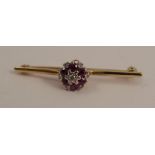 A ruby and diamond cluster bar brooch, stamped '18ct', 4.3cm long, 3.8g gross