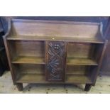 An set of oak wall shelves, the central cupboard with carved door surrounded by shelves, height