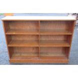 An oak bookcase, on plinth base, width 48.5ins, depth 11ins, height 36ins and three assorted sets of