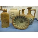 A pair of stoneware bottle jugs, by Kennedy of Glasgow, decorated with foliage and berries, height